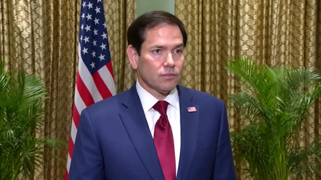 U.S. Secretary of State Marco Rubio standing in front of an American flag