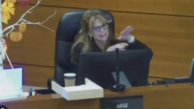 Judge Allison Gilman gestures from the bench during a court hearing.