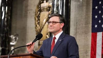 Mike Johnson speaks at a lectern in the U.S. House chamber.