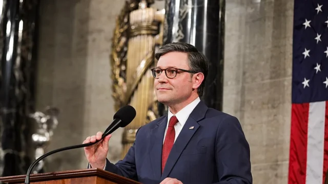 Mike Johnson speaks at a lectern in the U.S. House chamber.