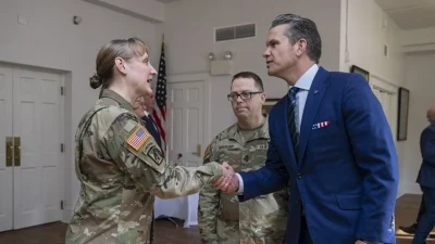 Pete Hegseth shakes hands with a service member at the U.S. Army War College.
