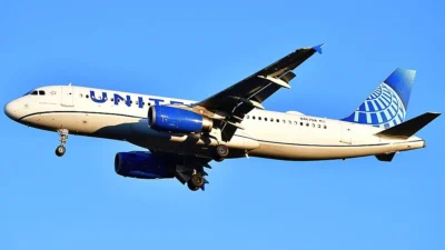 United Airlines Airbus A320 approaching Washington Dulles Airport with landing gear lowered.