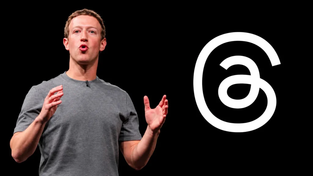 Meta CEO Mark Zuckerberg speaking on stage beside the Threads logo